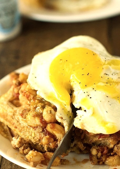 Chili and cornbread waffle stacks with an egg on top
